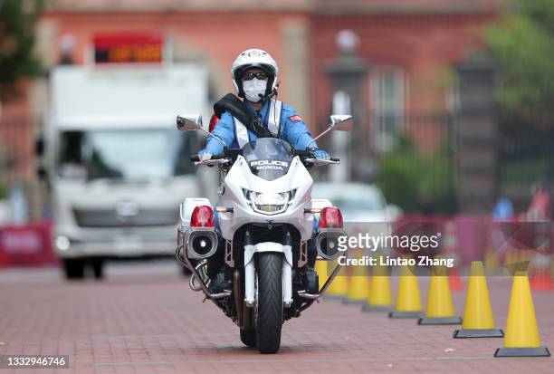 Police officer rides a motorcycle during the Men's Marathon Final on day sixteen of the Tokyo 2020 Olympic Games at Sapporo Odori Park on August 08,...