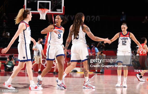 Ja Wilson of Team United States high-fives teammate as Brittney Griner high-fives Diana Taurasi during the first half of the Women's Basketball final...