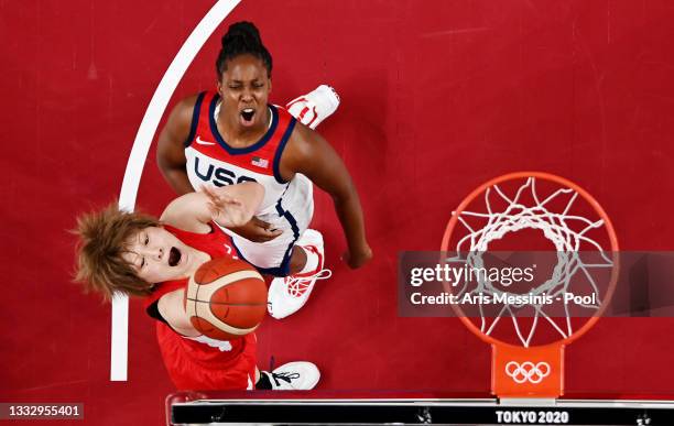 Maki Takada of Team Japan drives to the basket against Chelsea Gray of Team United States during the first half of the Women's Basketball final game...