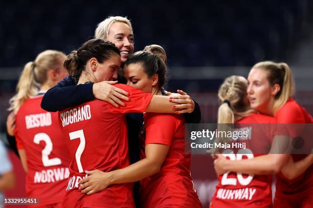 Stine Skogrand, Katrine Lunde and Nora Moerk of Team Norway embrace each other after defeating Team Sweden 36-19 to win the bronze medal in Woman's...