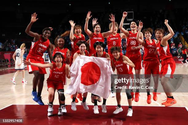 Team Japan celebrates taking the silver medal after the Women's Basketball final game between Team United States and Team Japan on day sixteen of the...