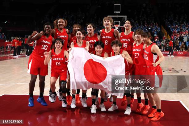 Team Japan celebrates taking the silver medal after the Women's Basketball final game between Team United States and Team Japan on day sixteen of the...