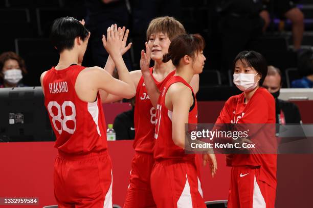 Maki Takada of and Himawari Akaho of Team Japan celebrate winning the silver medal in the Women's Basketball final game between Team United States...