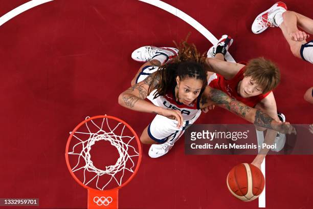 Brittney Griner of Team United States and Maki Takada of Team Japan compete for a rebound during the second half of the Women's Basketball final game...