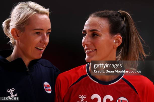 Katrine Lunde and Marta Tomac of Team Norway leave the field of play after defeating Team Sweden 36-19 to win the bronze medal in Woman's Handball on...