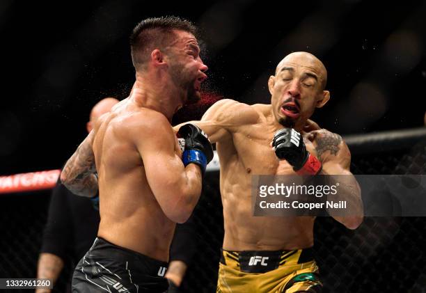 Jose Aldo of Brazil punches Pedro Munhoz of Brazil in their bantamweight bout during the UFC 265 event at Toyota Center on August 07, 2021 in...