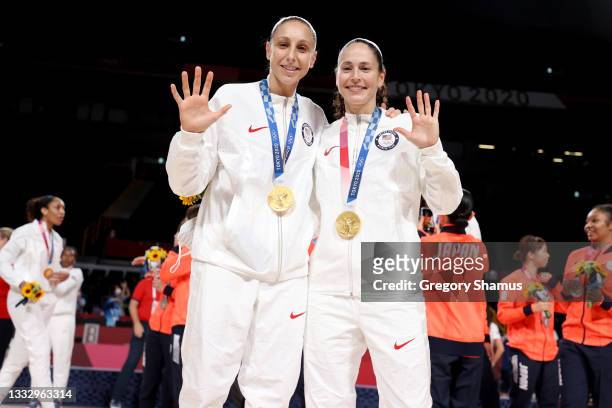 Sue Bird of Team United States and Diana Taurasi pose for photographs with their gold medals during the Women's Basketball medal ceremony on day...