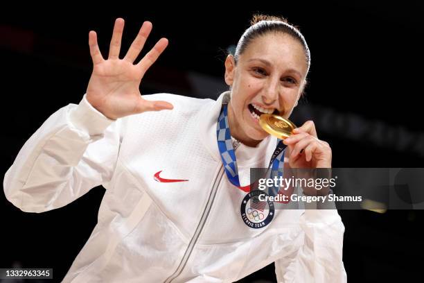 Diana Taurasi of Team United States bites her gold medal during the Women's Basketball medal ceremony on day sixteen of the 2020 Tokyo Olympic games...