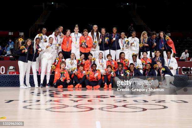 Team United States, Team Japan and Team France pose for photographs with their medals during the Women's Basketball medal ceremony on day sixteen of...