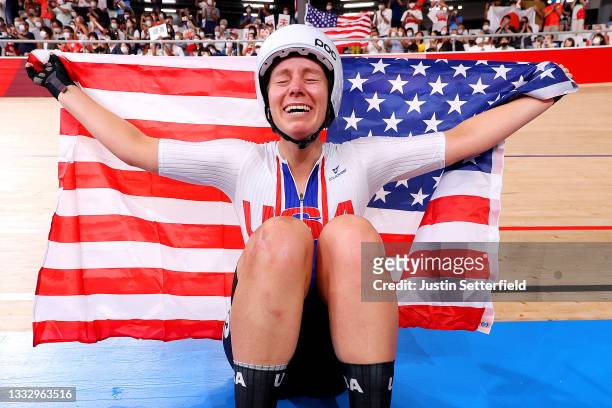 Jennifer Valente of Team United States celebrates winning the gold medal while holding the flag of her country during the Women's Omnium points race,...