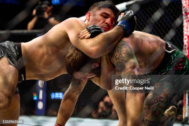 Vicente Luque of Brazil submits Michael Chiesa in their welterweight bout during the UFC 265 event at Toyota Center on August 07, 2021 in Houston,...