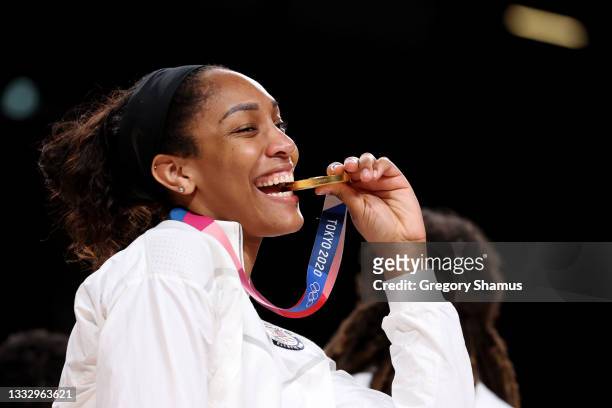 Ja Wilson of Team United States bites her gold medal during the Women's Basketball medal ceremony on day sixteen of the 2020 Tokyo Olympic games at...