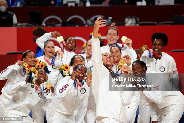 Brittney Griner of Team United States takes a selfie with her teammates and their gold medals during the Women's Basketball medal ceremony on day...