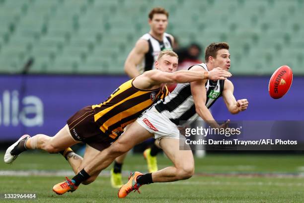 Tom Mitchell of the Hawks tackles Josh Thomas of the Magpies during the round 21 AFL match between Hawthorn Hawks and Collingwood Magpies at the...