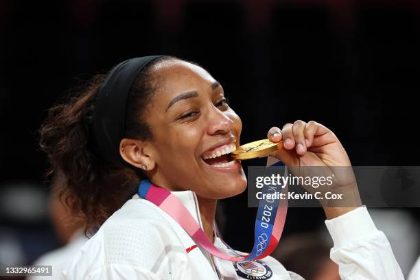 Ja Wilson of Team United States bites her gold medal during the Women's Basketball medal ceremony on day sixteen of the 2020 Tokyo Olympic games at...