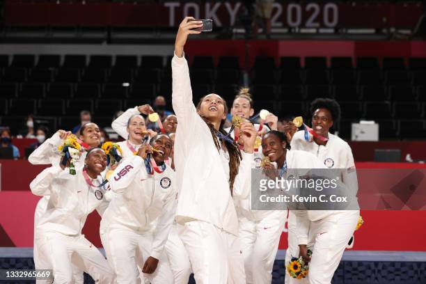 Brittney Griner of Team United States takes a selfie with her teammates and their gold medals during the Women's Basketball medal ceremony on day...