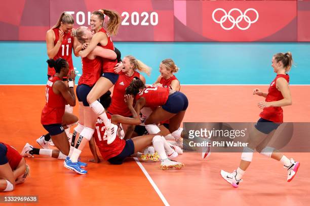 Players of Team United States react after defeating Team Brazil during the Women's Gold Medal Match on day sixteen of the Tokyo 2020 Olympic Games at...