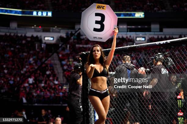 Octagon Girl Luciana Andrade signals the start of round three between Derrick Lewis and Ciryl Gane of France in their interim heavyweight title bout...