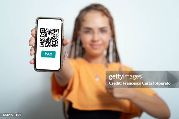 woman shows her smartphone with the qr code for payment - hand showing stock-fotos und bilder