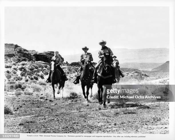 Joan Staley and Warren Stevens lead a posse into an abandoned Spanish pueblo in a scene from the film 'Gunpoint', 1966.