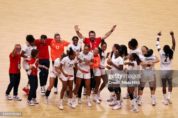 Estelle Nze Minko and Beatrice Edwige of Team France celebrates with teammates after defeating Team ROC 30-25 to win the gold medal in Women's...