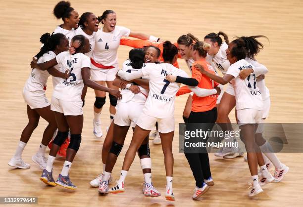 Grace Zaadi Deuna , Beatrice Edwige and Allison Pineau of Team France celebrates with teammates after defeating Team ROC 30-25 to win the gold medal...