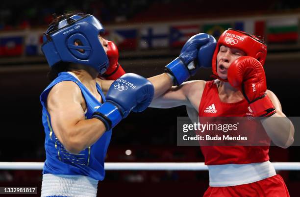 Lauren Price of Team Great Britain and Qian Li of Team China in action during the Women's Middle Final bout on day sixteen of the Tokyo 2020 Olympic...