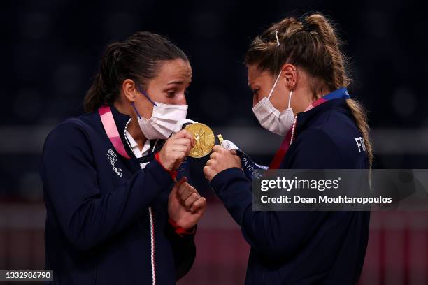 Pauline Coatanea and Chloe Valentini of Team France react with their gold medals during the medal ceremony for Women's Handball on day sixteen of the...
