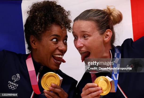 Estelle Nze Minko and Amandine Leynaud of Team France celebrate with their gold medals during the medal ceremony for Women's Handball on day sixteen...