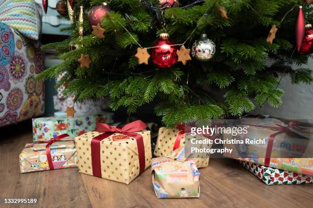many christmas presents under wonderful christmas tree - christmas presents under tree stock pictures, royalty-free photos & images