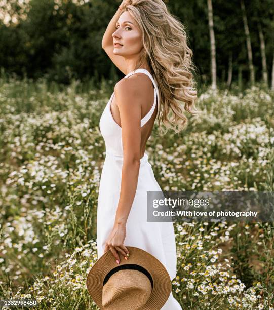 young adult woman outdoors in camomile field enjoying summer - beautiful woman 40 stock pictures, royalty-free photos & images