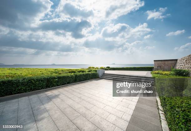 walkway in the seaside park - dramatic sky perspective stock pictures, royalty-free photos & images