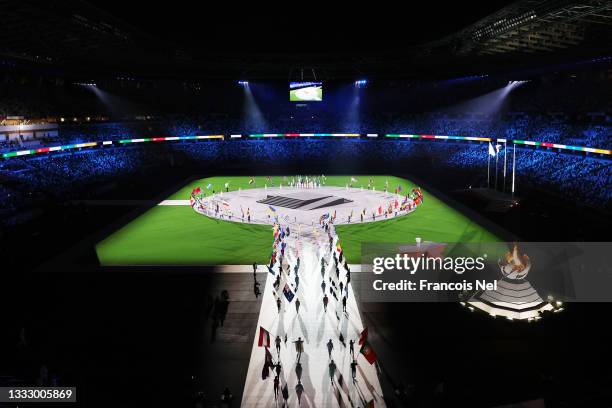 View as the flag bearers of the competing nations enter the stadium during the Closing Ceremony of the Tokyo 2020 Olympic Games at Olympic Stadium on...