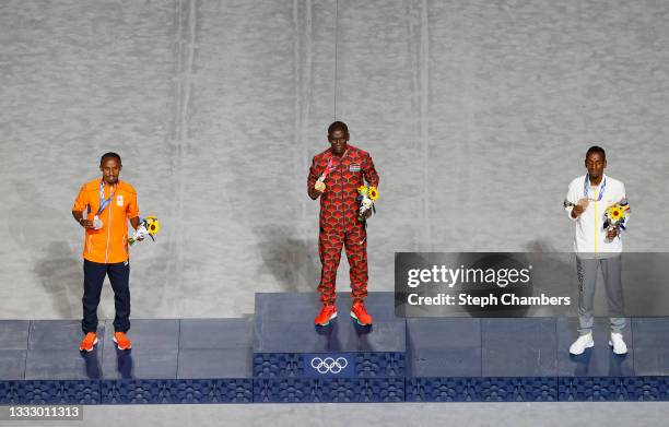 Silver medalist Abdi Nageeye of Team Netherlands, gold medalist Eliud Kipchoge of Team Kenya and bronze medalist Bashir Abdi of Team Belgium pose...
