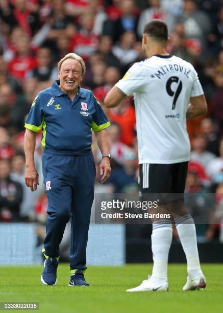 The Middlesbrough Manager, Neil Warnock shares a joke with Aleksandar Mitrovic of Fulham prior to the Sky Bet Championship match between Fulham and...
