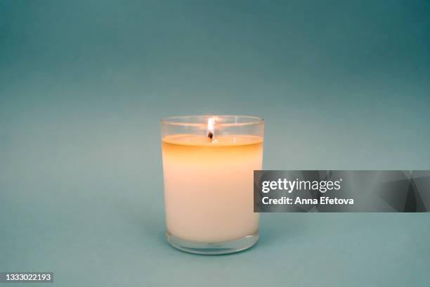 burning candle on gray background. set for aromatherapy and rituals. copy space for your design. front view - candel stock-fotos und bilder