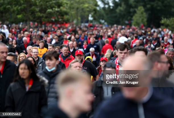 Fans arrive to the stadium ahead of the pre-season friendly match between Liverpool and Athletic Club at Anfield on August 08, 2021 in Liverpool,...