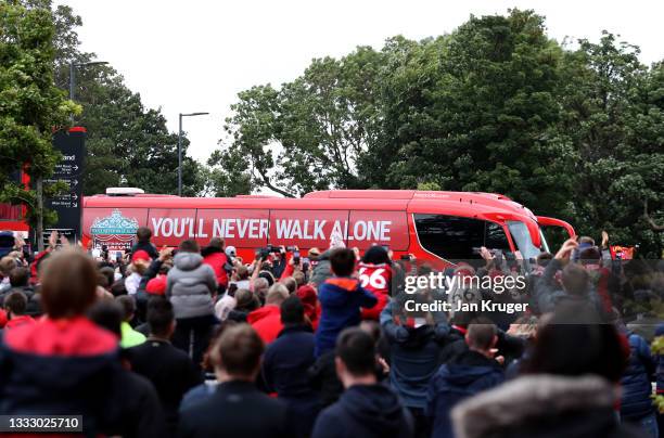 Fans cheer as the team arrive ahead of the pre-season friendly match between Liverpool and Athletic Club at Anfield on August 08, 2021 in Liverpool,...