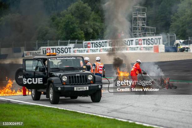 Dani Pedrosa's bike - marshals extinguish fire during the MotoGP race - Michelin Grand Prix of Styria at Red Bull Ring on August 08, 2021 in...