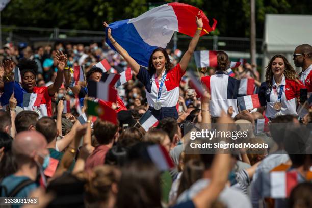Olympic athletes champions cheer a crowd during the Olympic Games handover ceremony on August 8, 2021 in Paris, France. On August 8, during the...