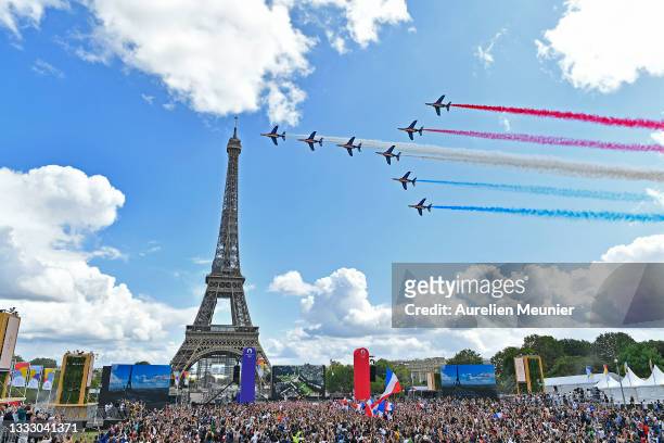 French Elite acrobatic team Patrouille de France flyes over the Eiffel Tower during the Olympic Games handover ceremony on August 08, 2021 in Paris,...