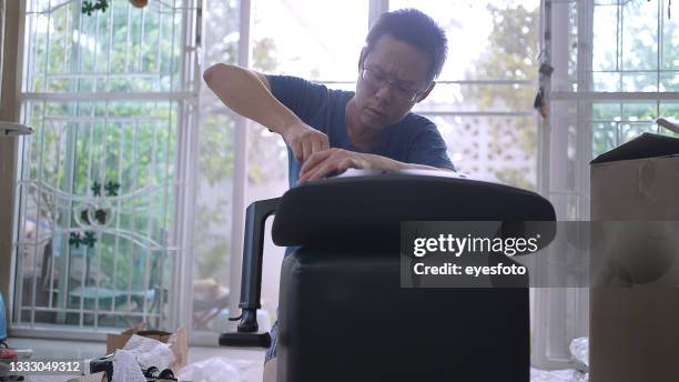 man build the chair. diy - tighten stock pictures, royalty-free photos & images