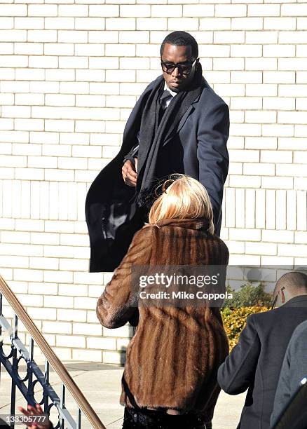 Rapper/record producer Sean "P Diddy" Combs helps his mother Janice Combs up the stairs at the funeral service for Heavy D at Grace Baptist Church on...