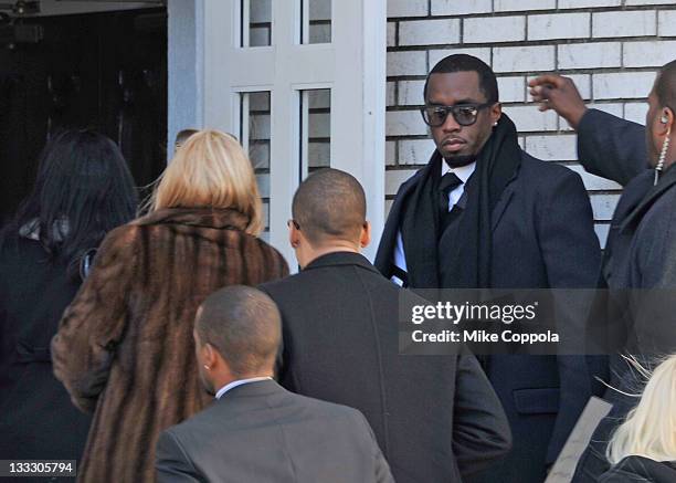 Rapper/record producer Sean "P Diddy" Combs hold the door open for his mother Janice Combs at the funeral service for Heavy D at Grace Baptist Church...