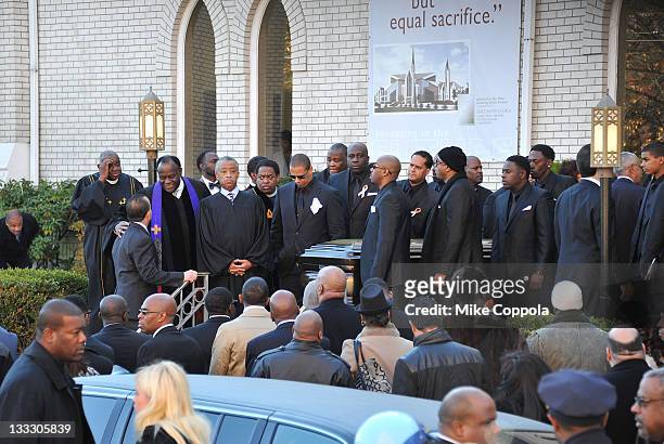 Reverend Al Sharpton joins pallbearers to help carry the casket of rapper Heavy D at his funeral service at Grace Baptist Church on November 18, 2011...