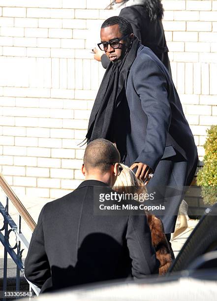 Rapper/record producer Sean "P Diddy" Combs helps his mother Janice Combs up the stairs at the funeral service for Heavy D at Grace Baptist Church on...