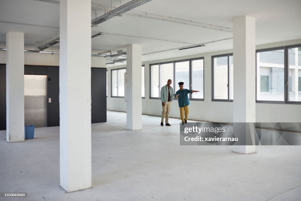 Commercial Real Estate Agent Showing Office Space to Client