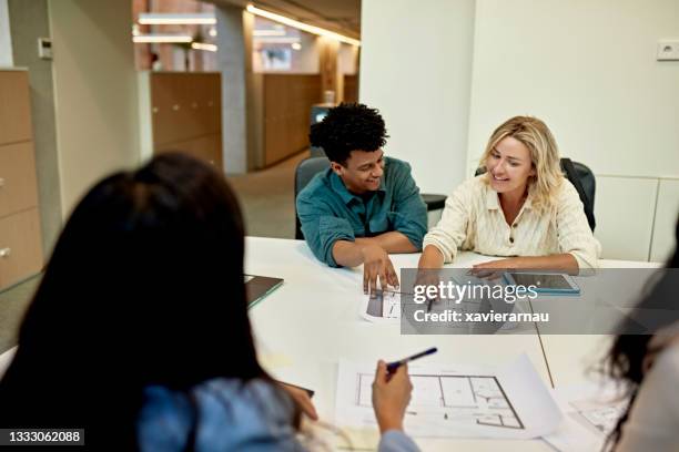 marketing team members examining property floor plan - commercial property imagens e fotografias de stock