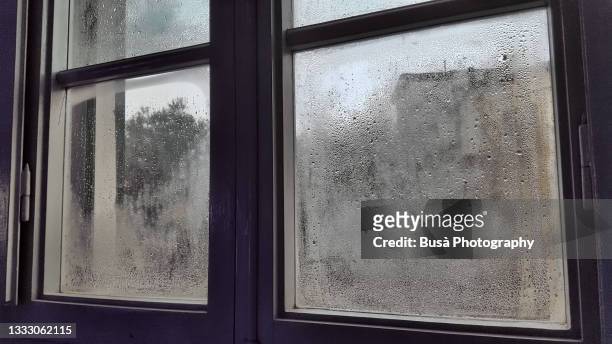 domestic room with rain droplets on window - window stock pictures, royalty-free photos & images