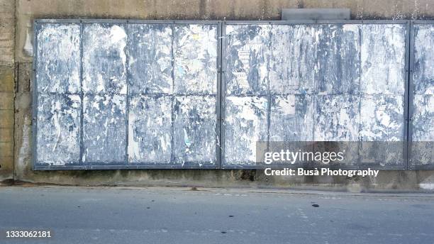 blank rusted billboard stand with scratched posters - billboard blank stock pictures, royalty-free photos & images